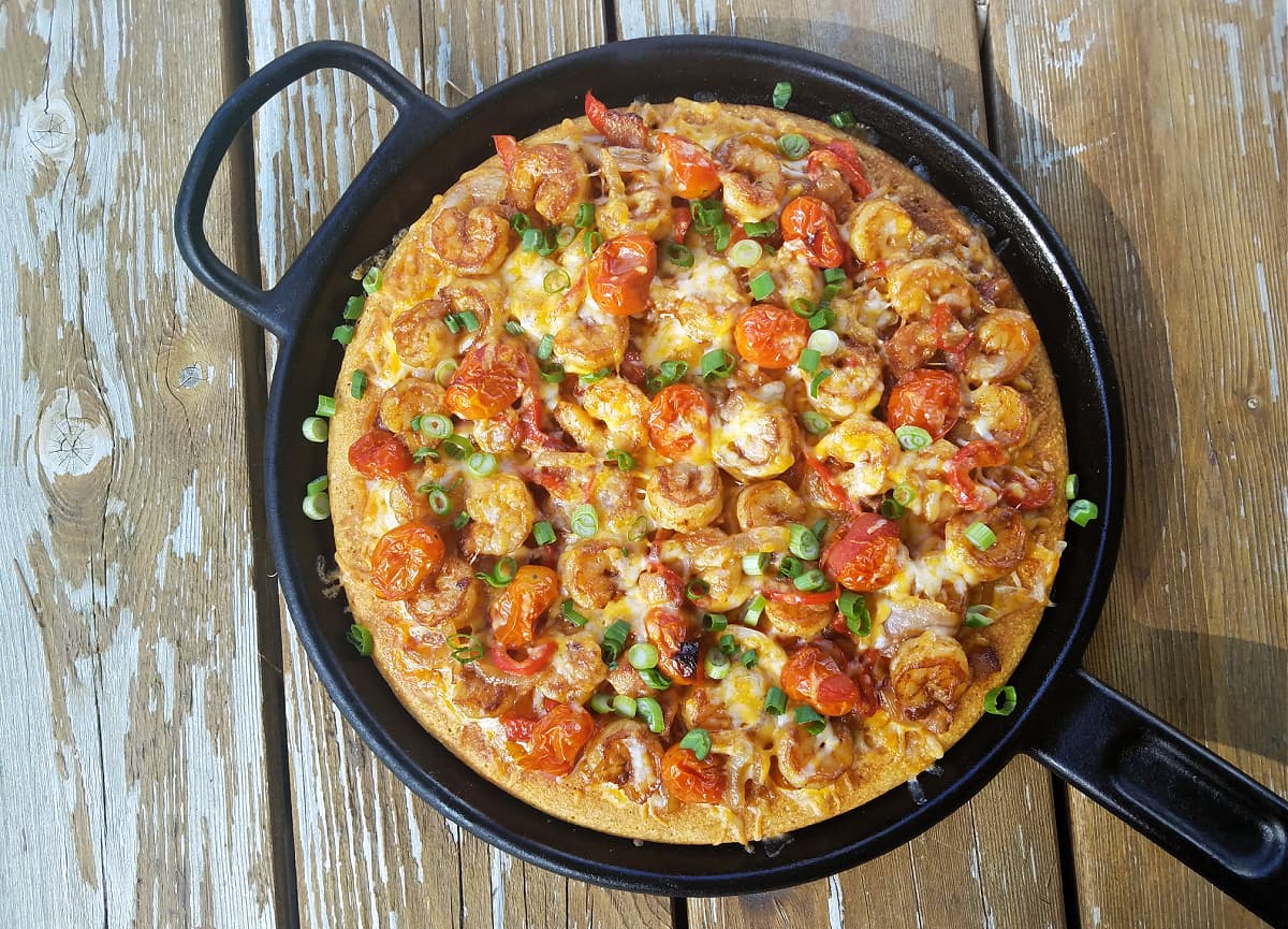 Whole shrimp & grits pizza cooked on cast iron griddle. 