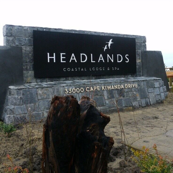 Headlands Coastal Lodge & Spa anchor sign with address. 