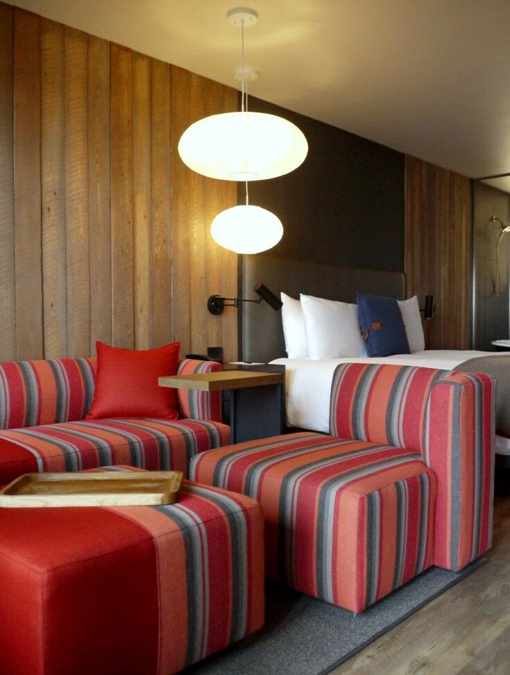 Interior of lodge room, with boxy striped cushions and couch. 