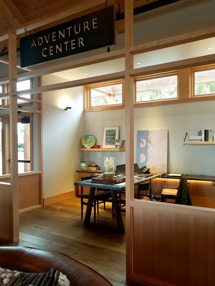 Adventure center office with map of Oregon coast in background. 