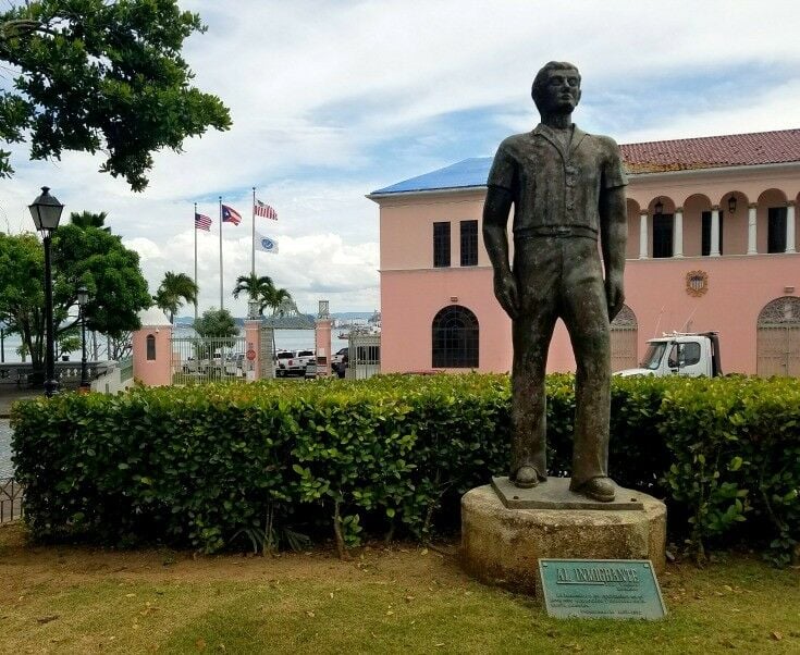 Monumento al Inmigrante (the Immigrant Monument) with harbor flags flying in the background. 