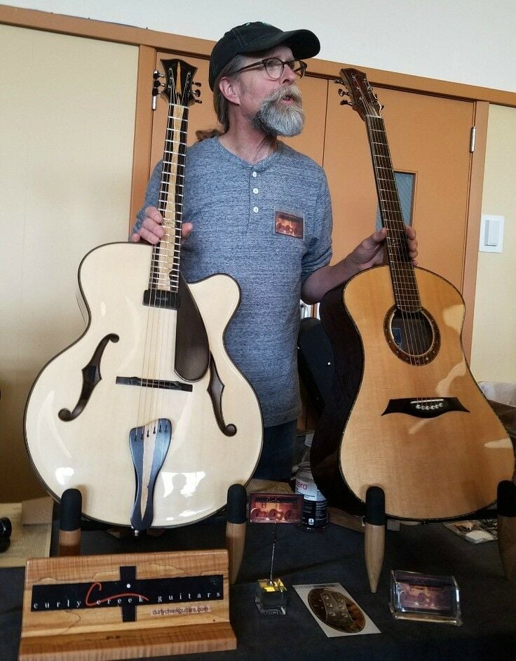 John Carrigan of Curly Creek Guitars of Port Orchard, WA shows off some of his handiwork.