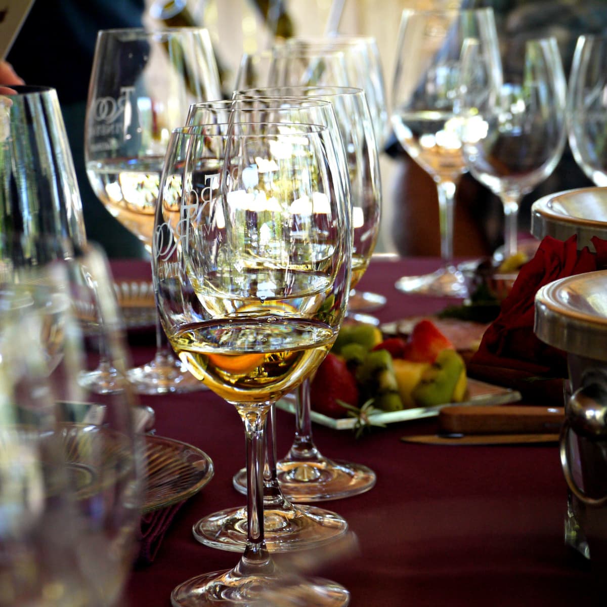 Wine glasses with tasting pours lined up on a table.