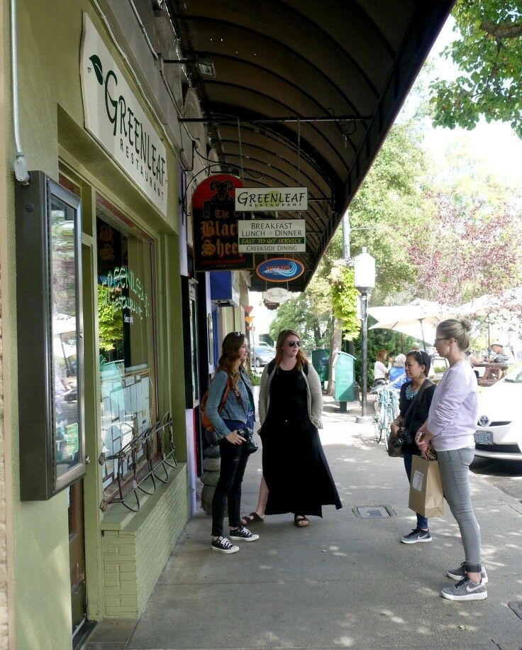 Women standing in front of the Greenleaf restaurant. 