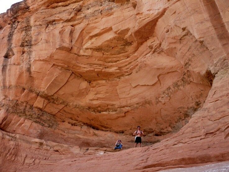 Kids standing in the mouth of the "Giant's Grin," on the trail to Delicate Arch. 