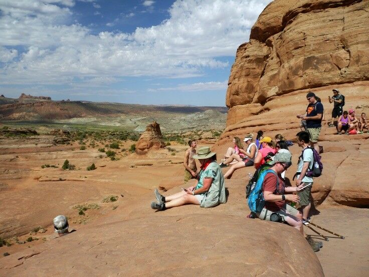 Hikers resting near the Delicate Arch before starting back down the trail. 