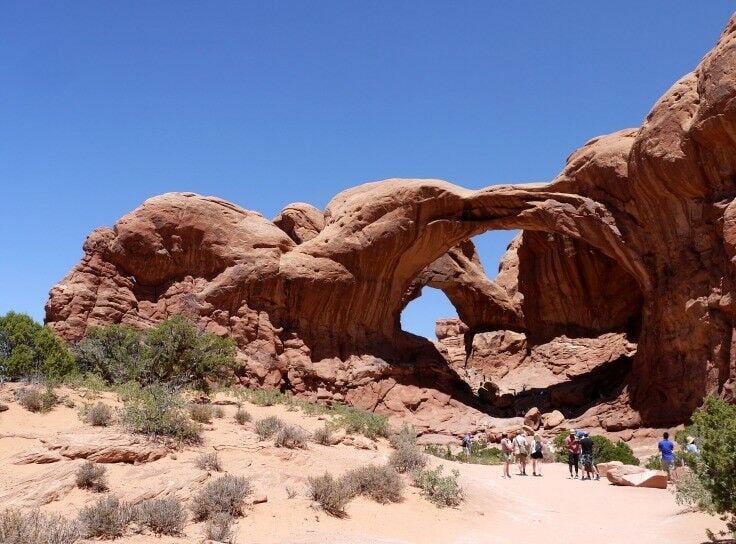 People standing near the Double Arch. 