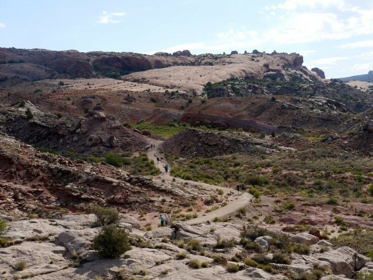 Trail winding upwards, cairns dotting the way.