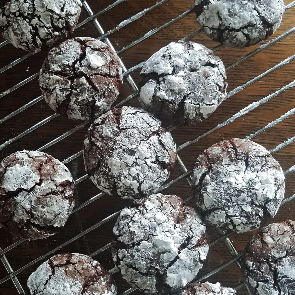 Chocolate crinkle cookies on a rack.