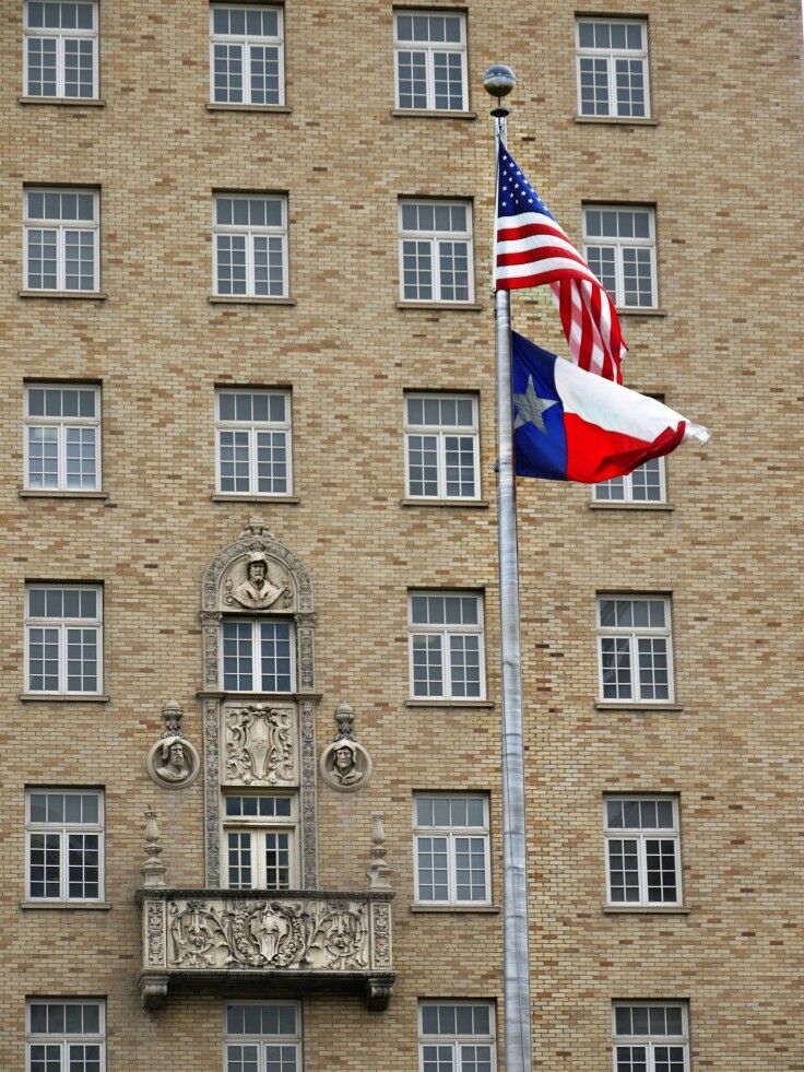 US and Texas flags flying in San Jacinto Plaza 