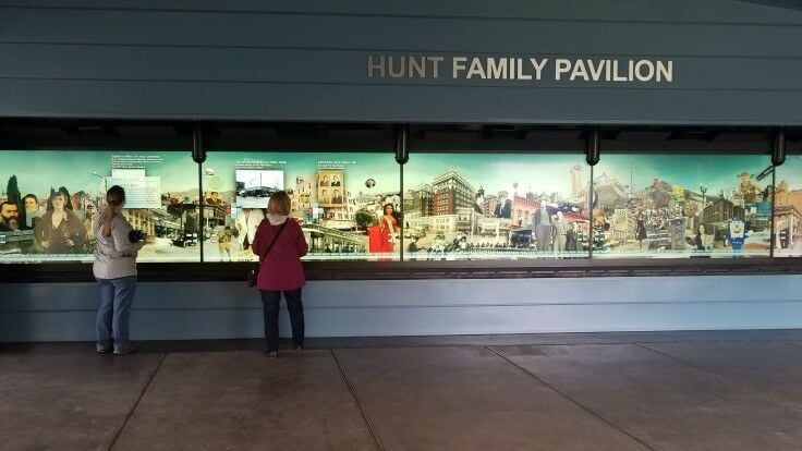 Women standing in front of a digital wall. 