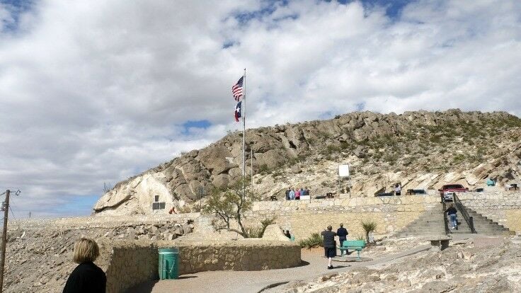 Flags and people on Scenic Drive outlook. 