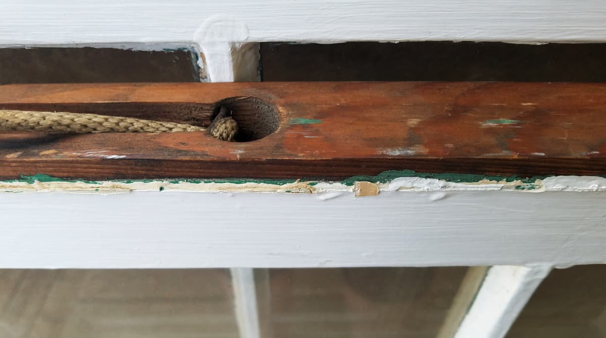 close-up of window sashing cord and sashing holes