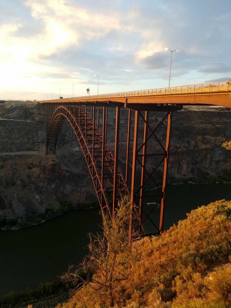 Perrine Bridge reflecting orange sunset. 