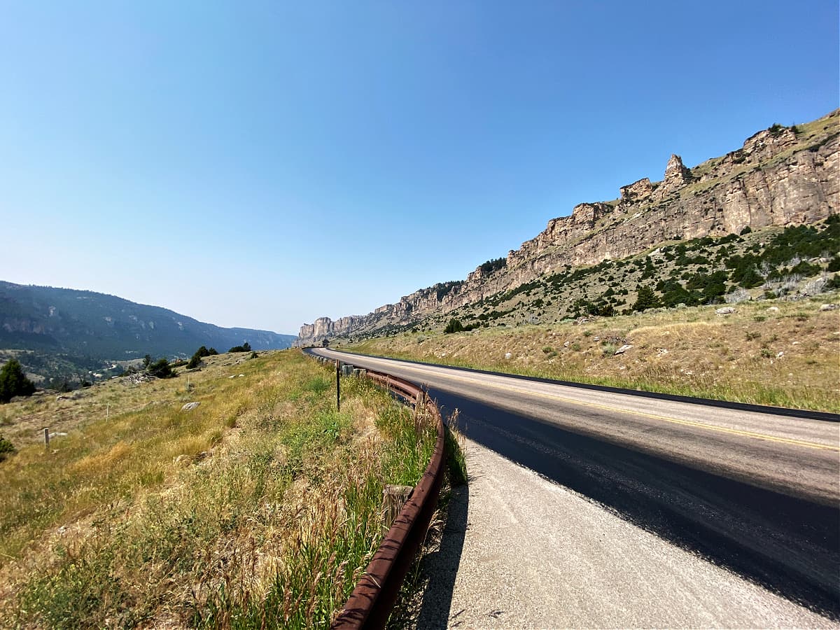 Long shot of curving highway leading up into Bighorn Mountains.