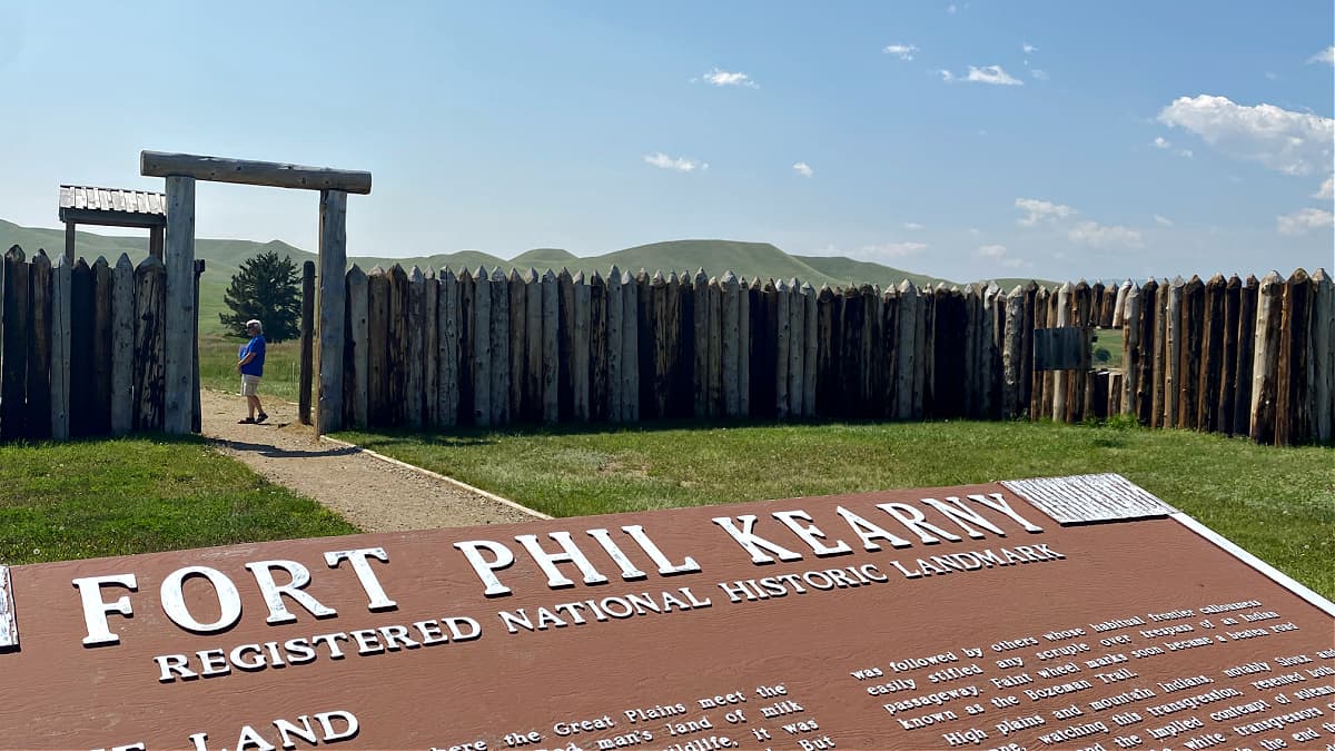 Sign in front of Fort Phil Kearny, with the fort facade in the background. 