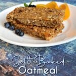 Two breakfast bars on a plate with orange slices and fresh berries. Pin text reads: Soft Baked Oatmeal Breakfast Bars