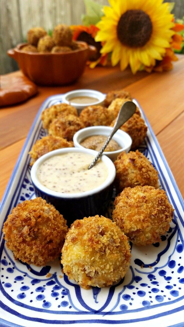 Sauerkraut Fritters with Bacon, Sausage & Cheese on blue and white rectangular tray. 