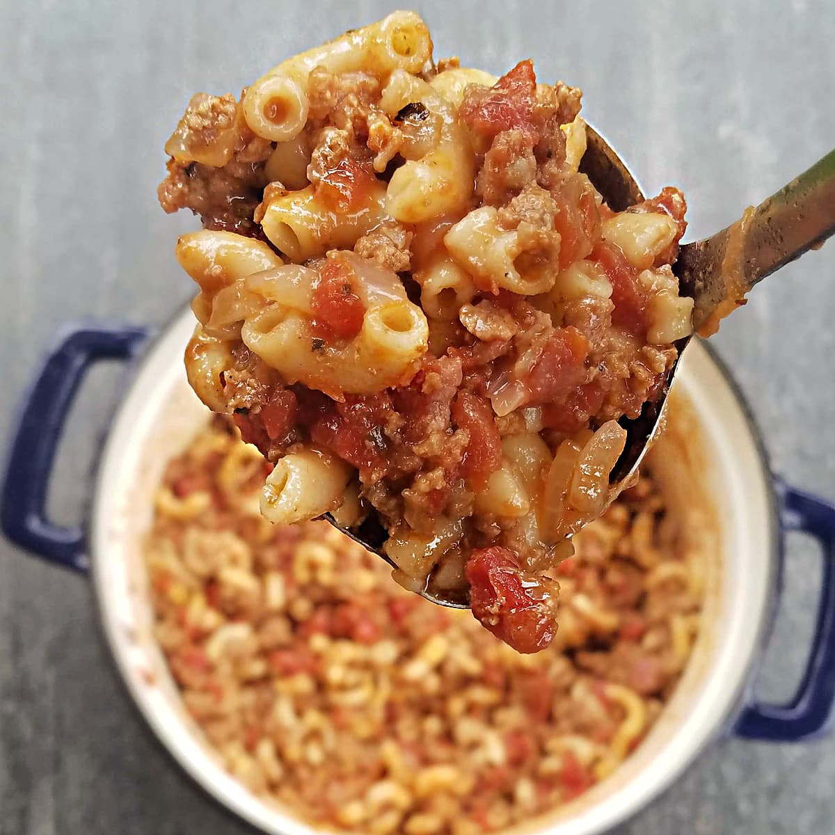 Close-up of a ladle-full of Grammi’s Classic Chili Mac recipe. 