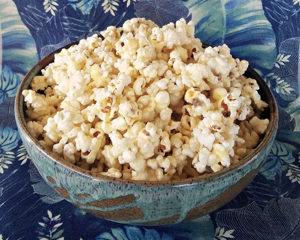 Caramel corn ready to serve in large clay bowl. 