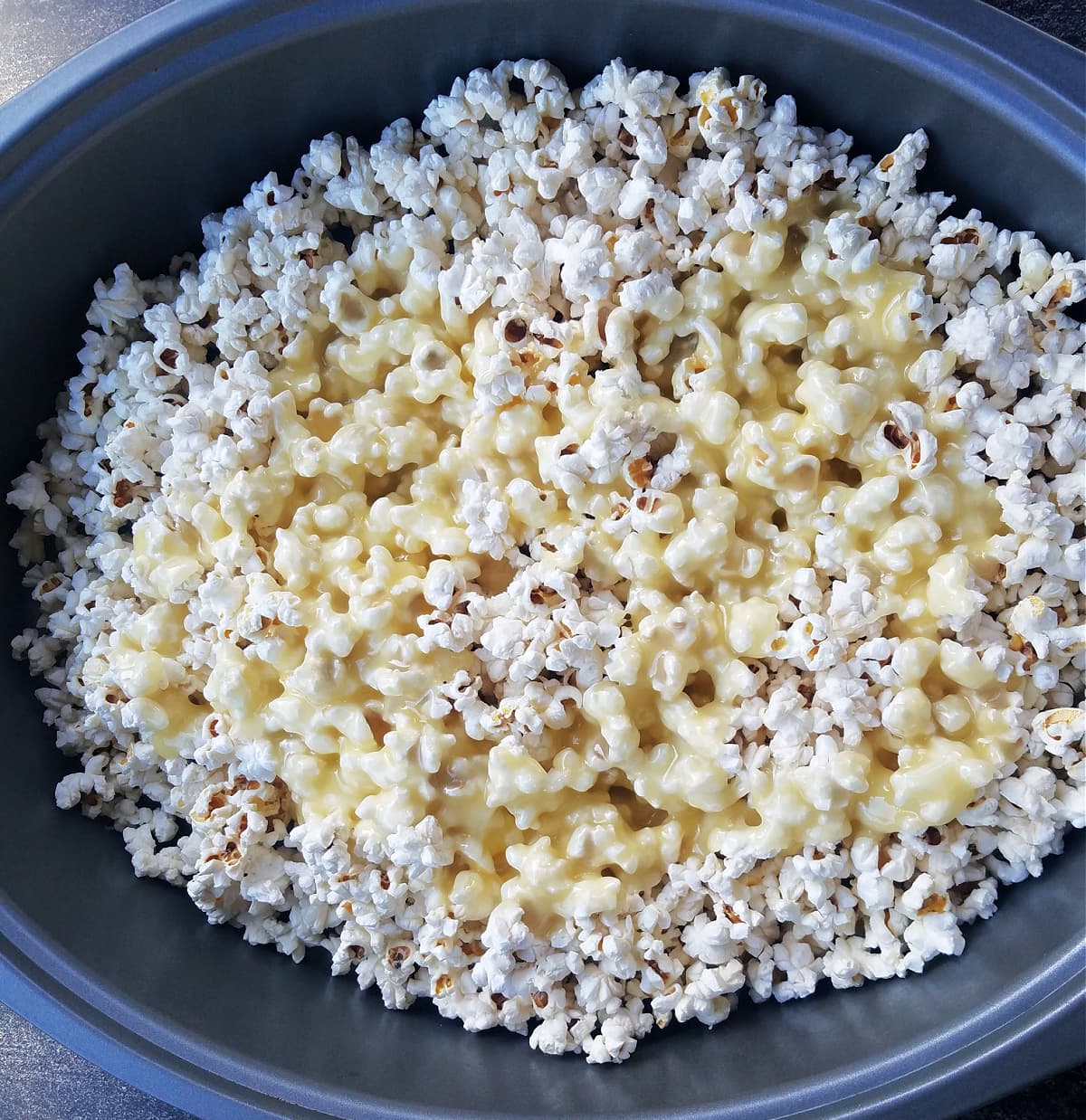 Butter and sugar mixture poured over popcorn in large roasting pan. 