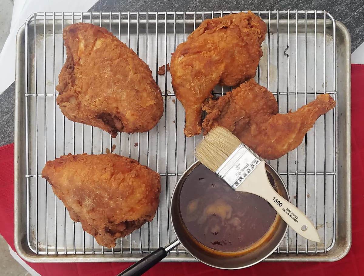 fried chicken pieces on a wire rack.