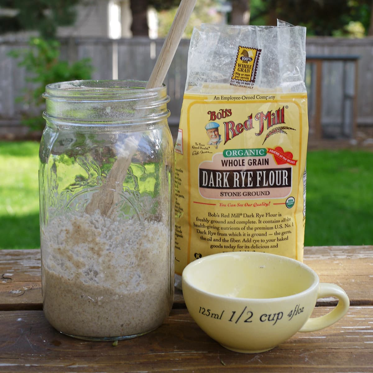 Premium Photo  Rye sourdough in a container, with a wooden spatula