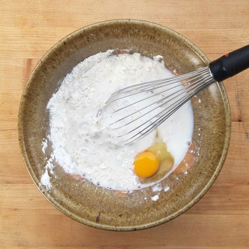 Pancake Batter ingredients in a crockery mixing bowl. 