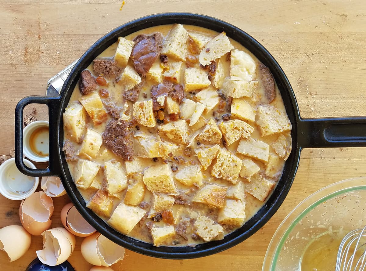 Unbaked bread pudding in a cast iron skillet.