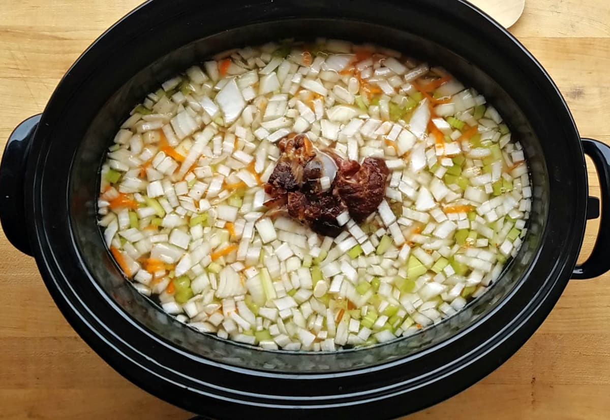 Bean soup ingredients in slow cooker, ready to cook. 