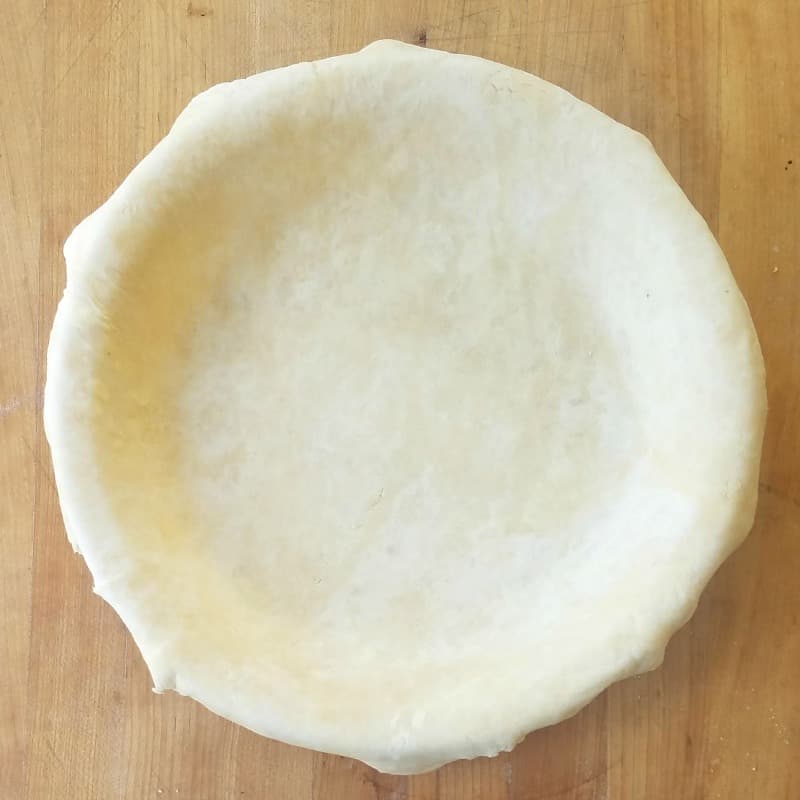 bottom pie crust draped in pie dish. 
