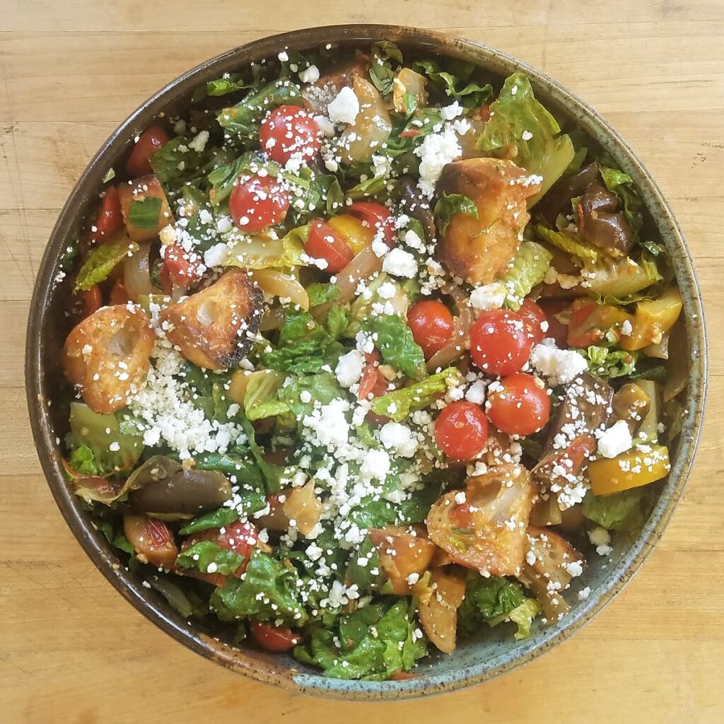 Large panzanella salad in family-sized serve bowl.