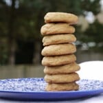 Eight snickerdoodle cookies stacked vertically on a blue plate.