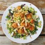 Overhead shot of Thai Shrimp Salad with Spicy Peanut Sauce on white plate.