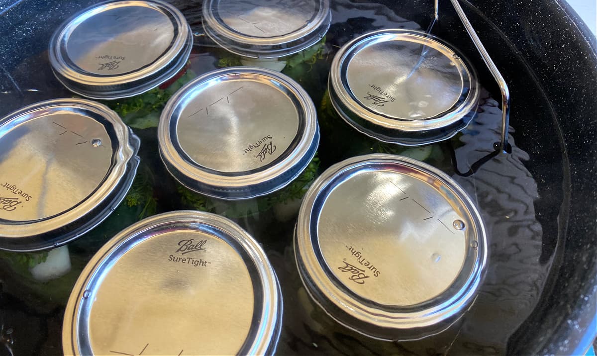 Water-bath canner filled with mason jars and ready to process.