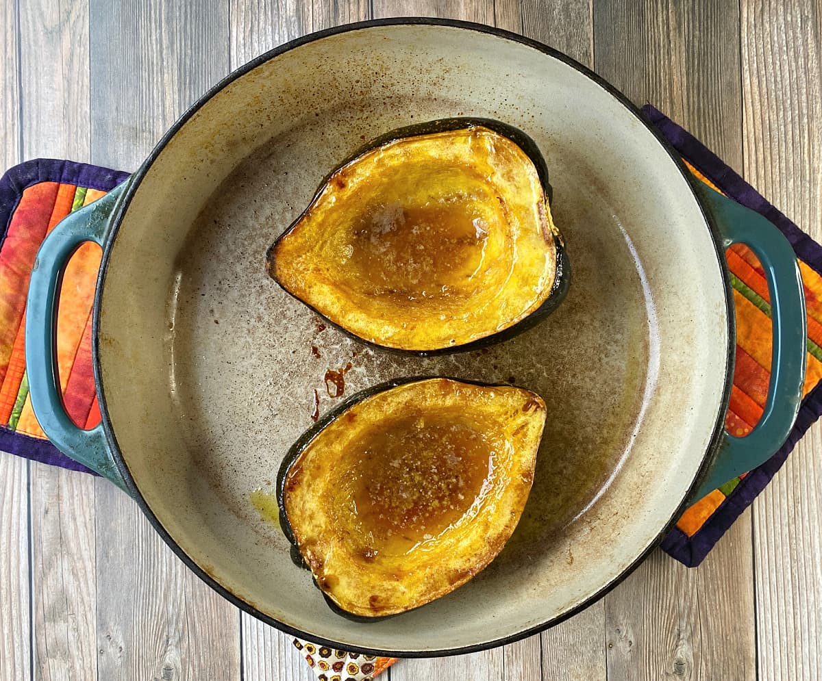 Tow halves acorn squash, baked, with liquified butter and brown sugar in cavities. 