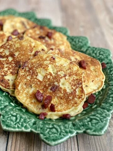 Plated mashed potato pancakes with corned beef.