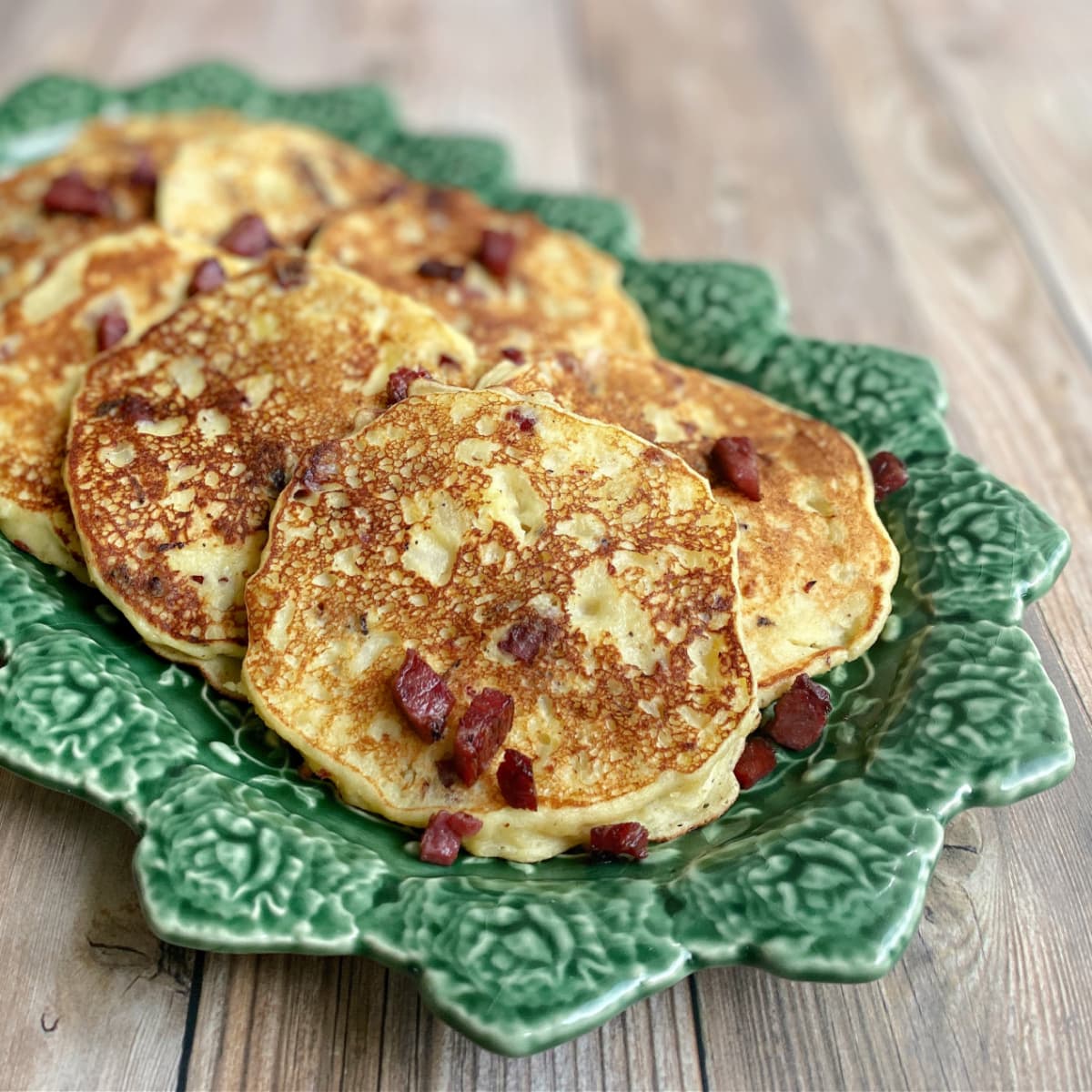 Plated mashed potato pancakes with corned beef.