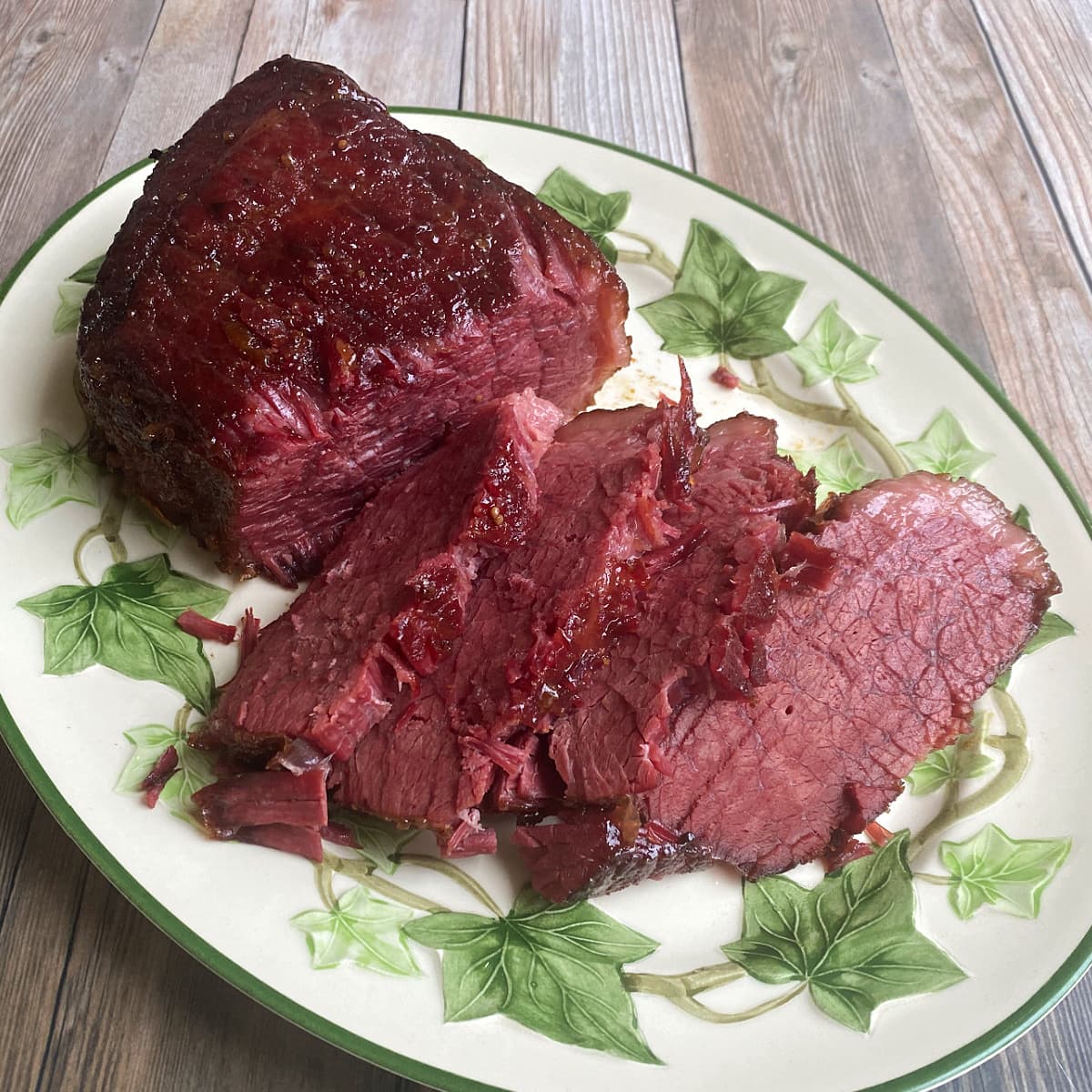 Corned beef prepared and sliced on Ivy patterned oval serving platter.