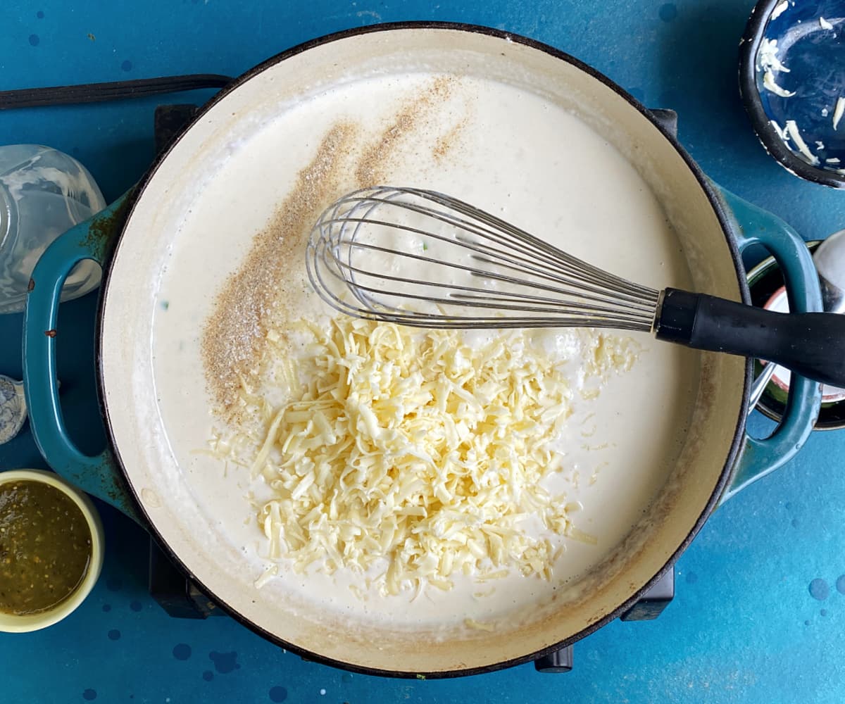 adding Jack cheese to white sauce mixture.