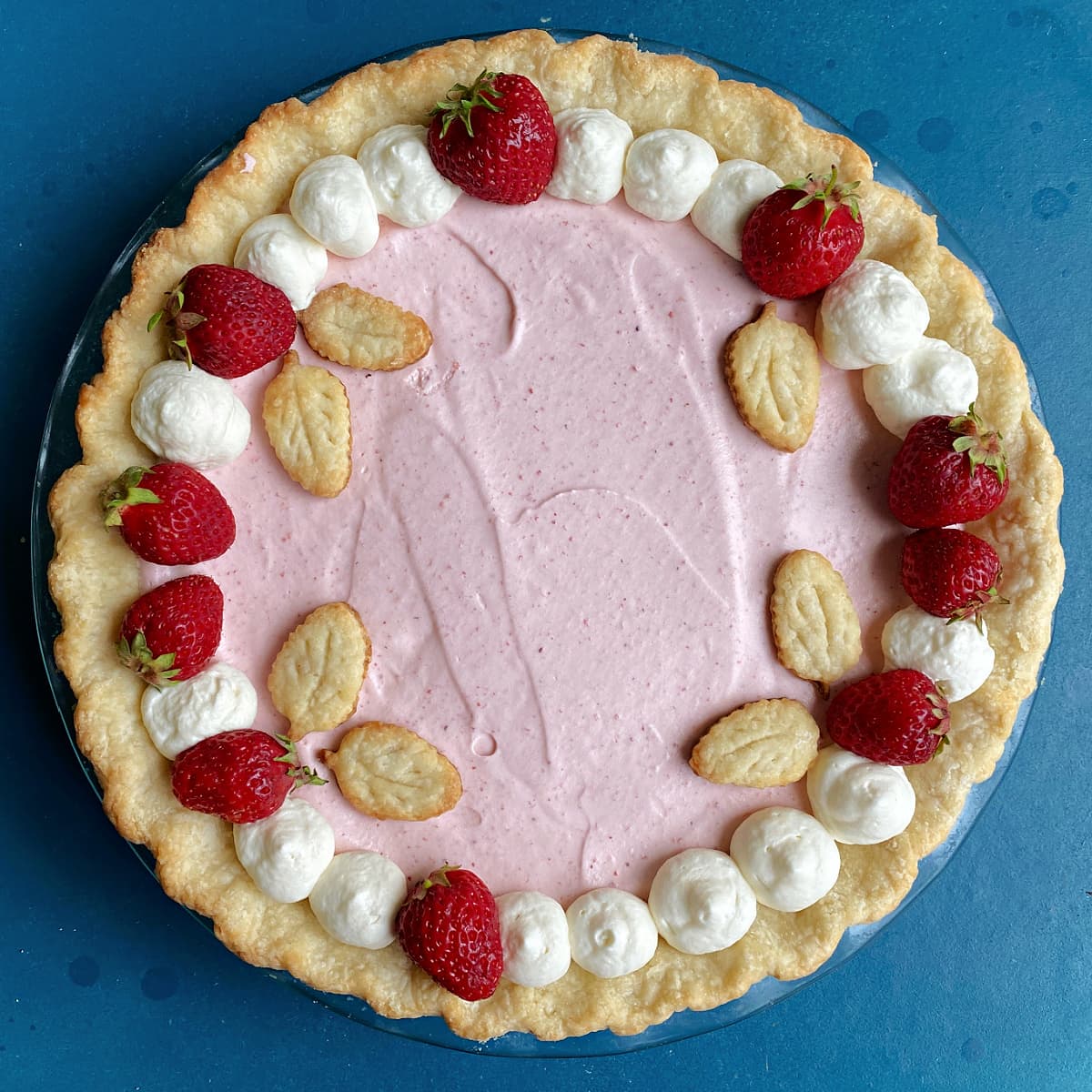 Fresh Strawberry Cream Pie, decorated with fresh Strawberries and pastry leaves.