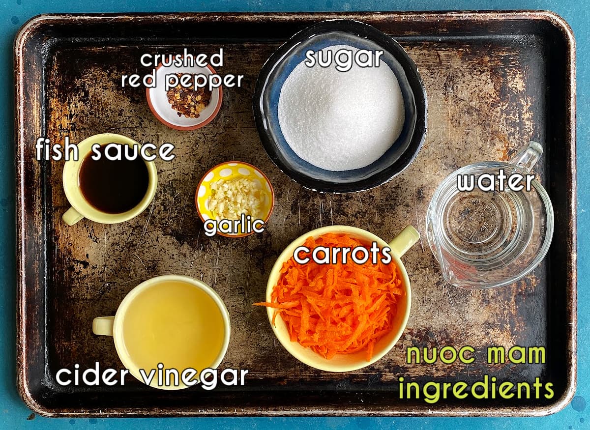 Nuoc mam ingredients, labeled: fish sauce, garlic, carrots, crushed red peppers, cider vinegar, sugar, water. 