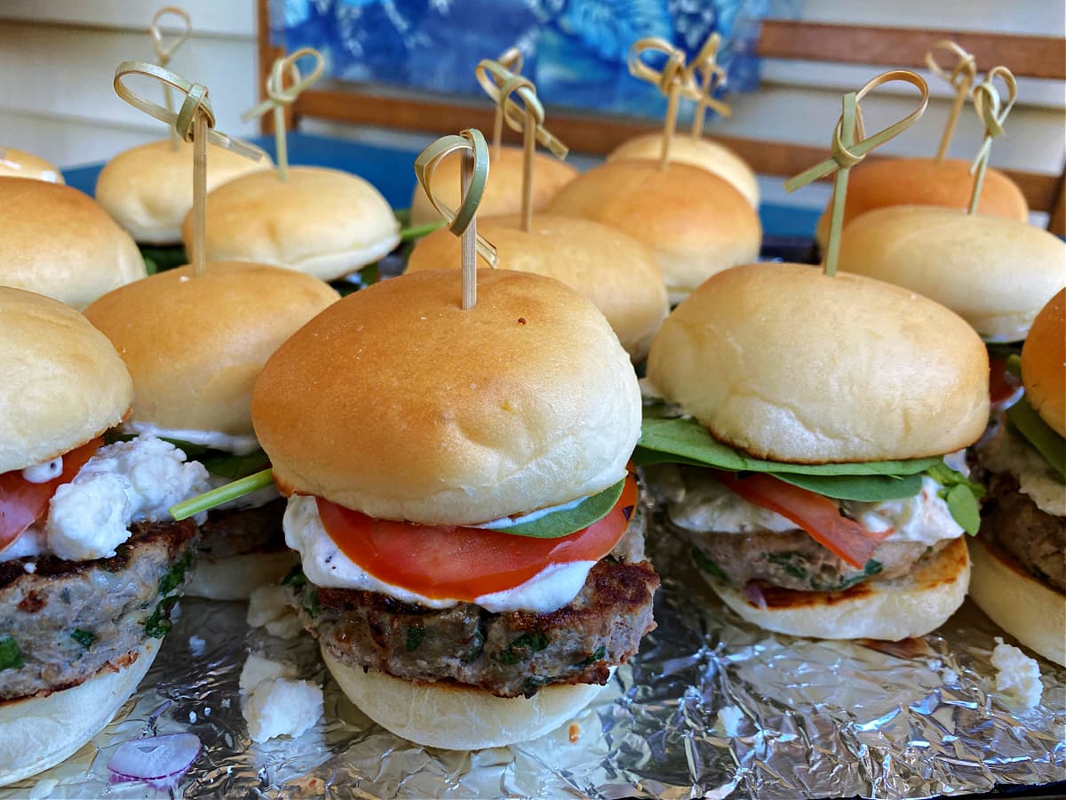 Small, palm-size Greek turkey burgers with a small bamboo skewer poked down through the middle for added structure. 