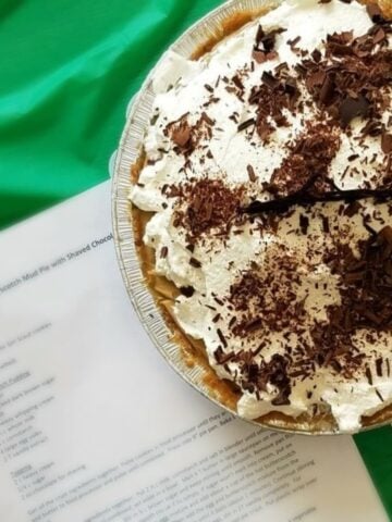 Overhead shot of Cream topped pie with shaved chocolate sprinkled over the top.
