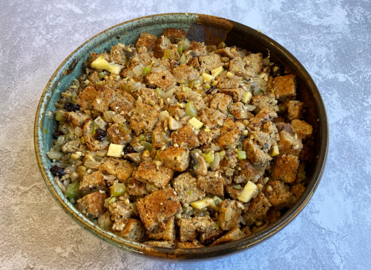 Mixed, unbaked stuffing in a large pottery bowl.