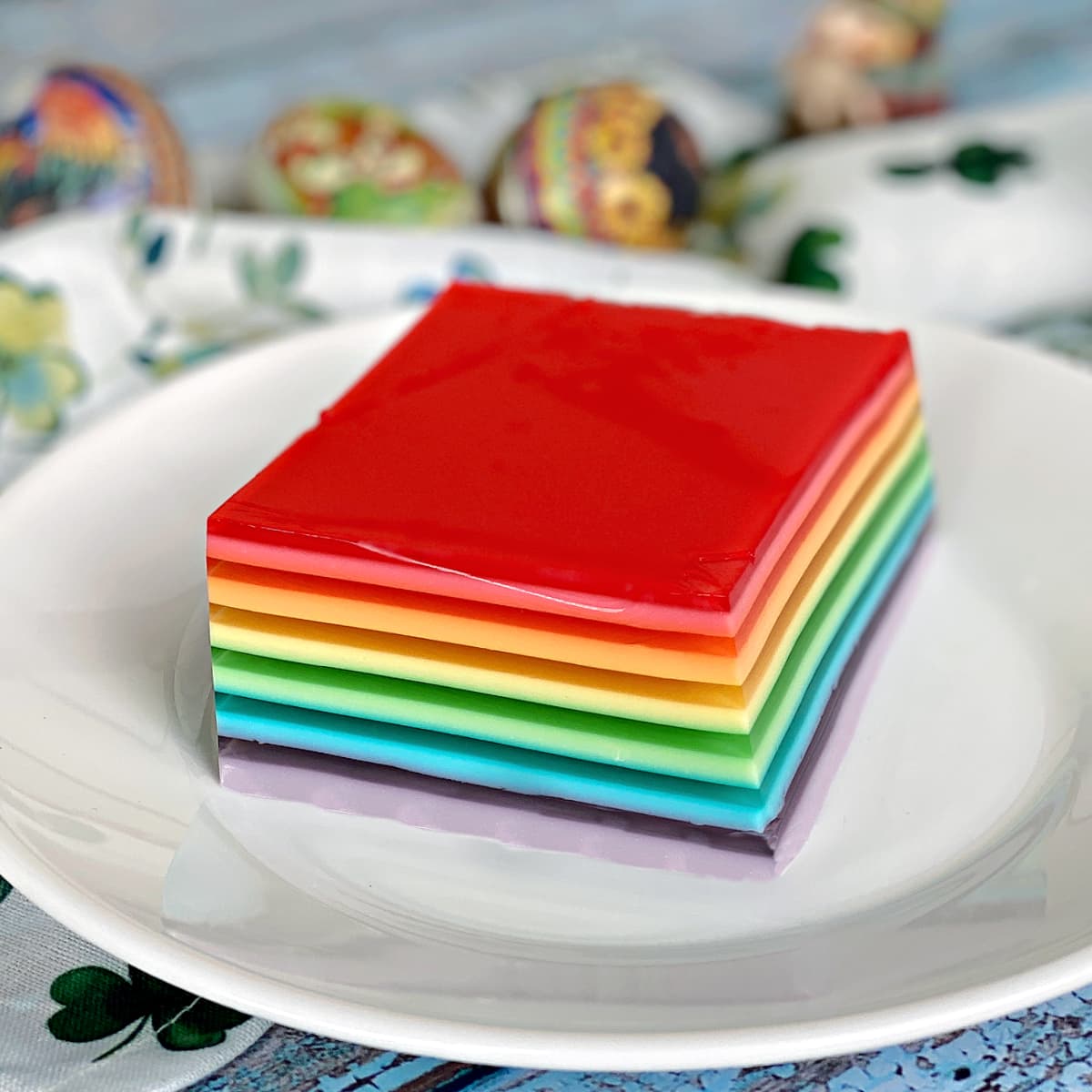 Single serving of rainbow jello on a small plate.