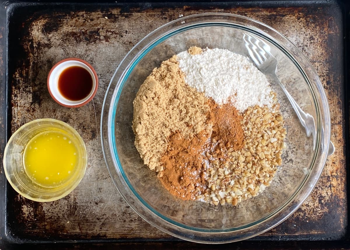 Dry ingredients for nut streusel topping in a glass mixing bowl.