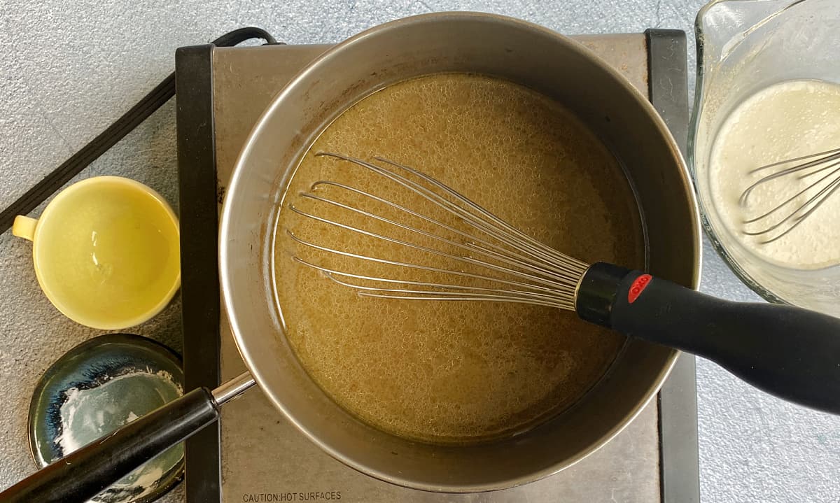 Saucepan about ¼ full of turkey stock, with a wire whisk in it.