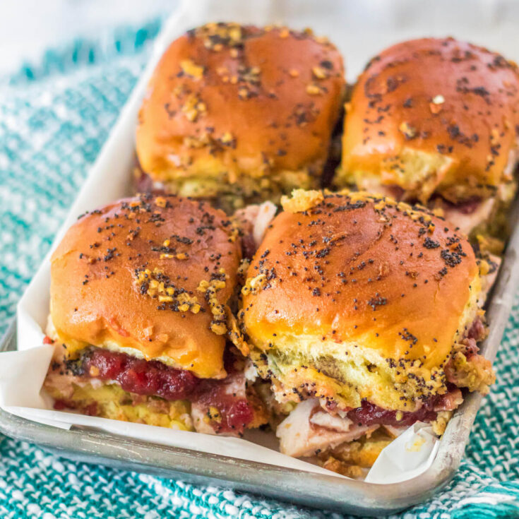 4 baked Hawaiian roll turkey slides on a plate