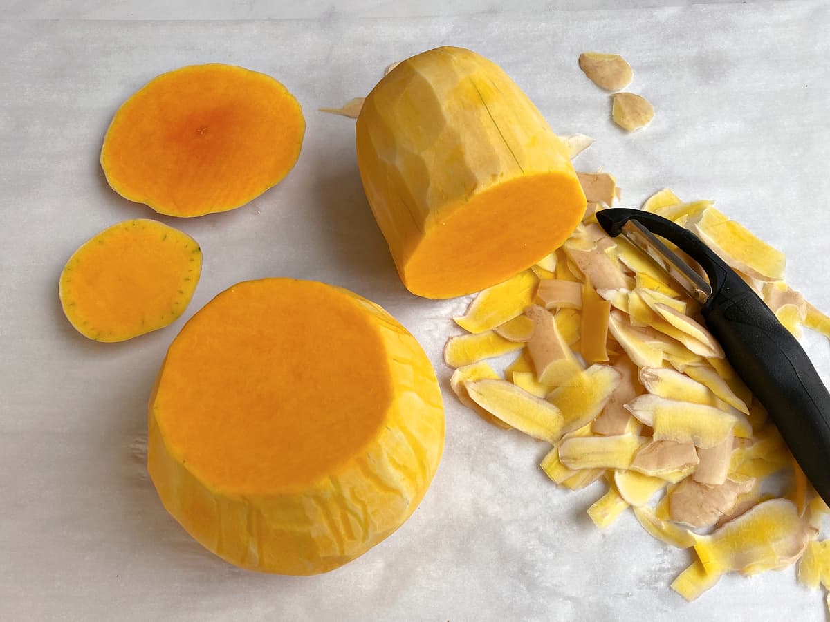 Use a vegetable peeler to peel the squash top and bottom.